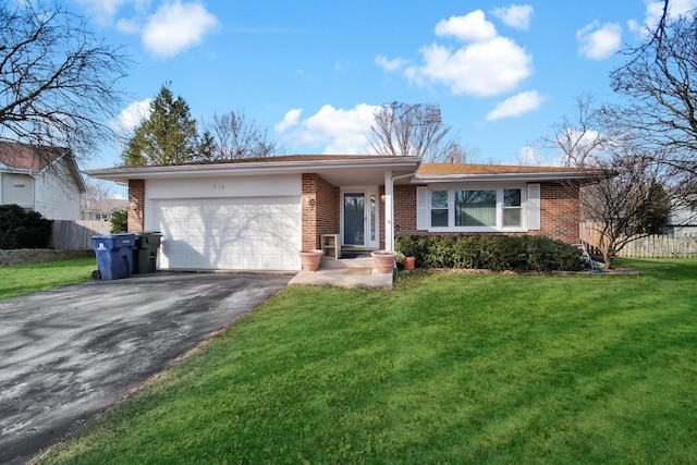 ranch-style house featuring brick siding, a front yard, an attached garage, and aphalt driveway