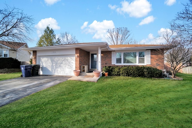 single story home featuring driveway, brick siding, an attached garage, fence, and a front yard