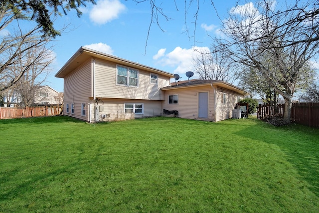 back of house with fence and a lawn