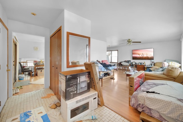 interior space featuring light wood finished floors, a closet, and a ceiling fan