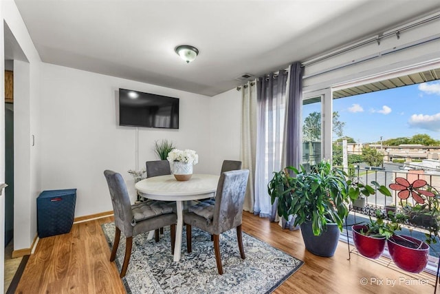 dining room with baseboards and wood finished floors