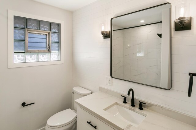 full bathroom with vanity and toilet