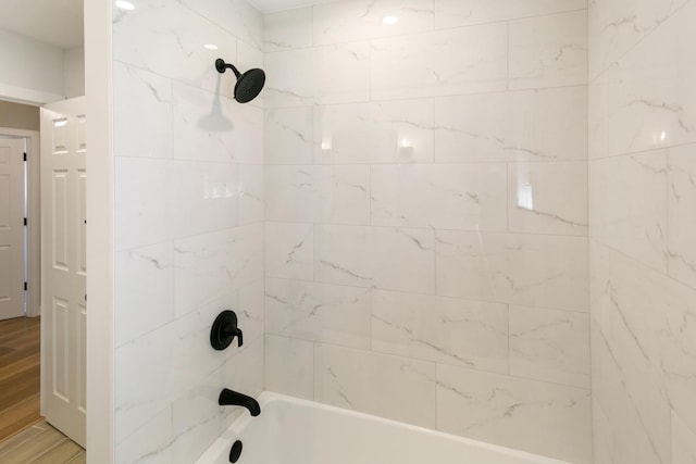 bathroom with wood finished floors and shower / bathing tub combination