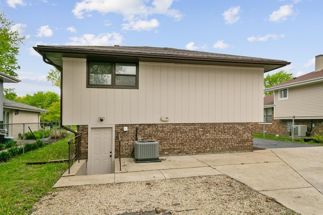 14951 Kilbourne Ave, Midlothian, IL 60445 - back of property with central AC unit, brick siding, and fence