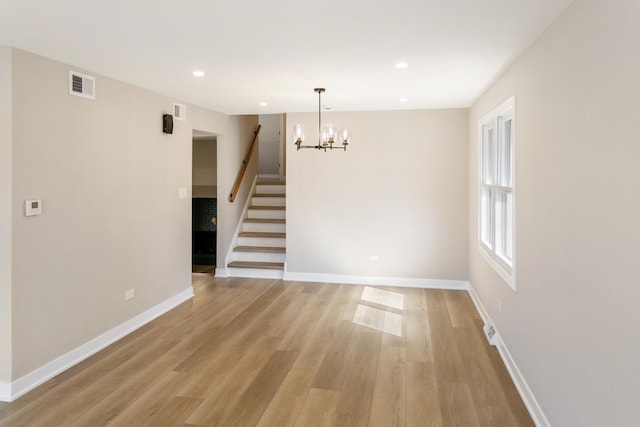 unfurnished dining area featuring light wood-type flooring, visible vents, stairway, and recessed lighting