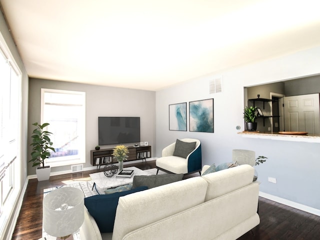 living area with dark wood-style flooring, visible vents, and baseboards