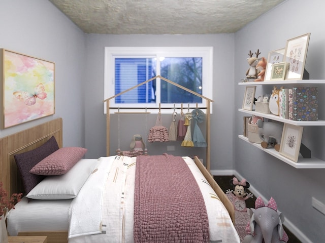 bedroom with baseboards and a textured ceiling