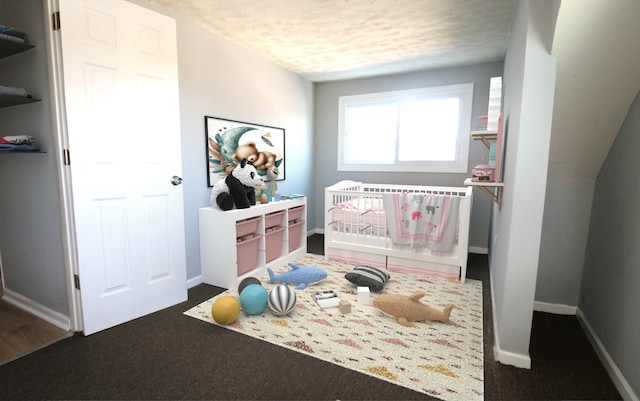 rec room with carpet, baseboards, and a textured ceiling