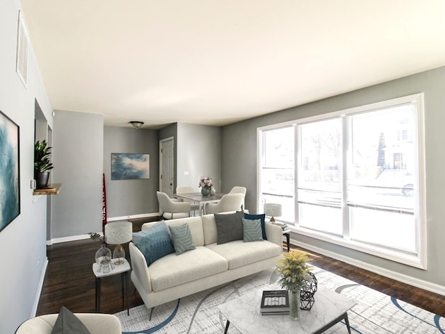 living area with dark wood finished floors and baseboards