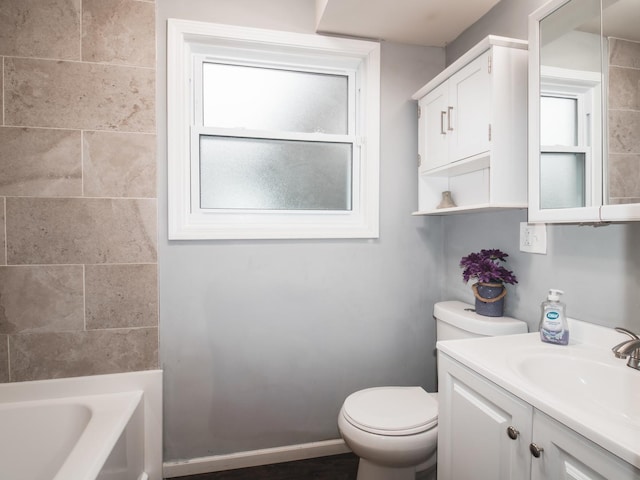 bathroom featuring vanity, toilet, and baseboards