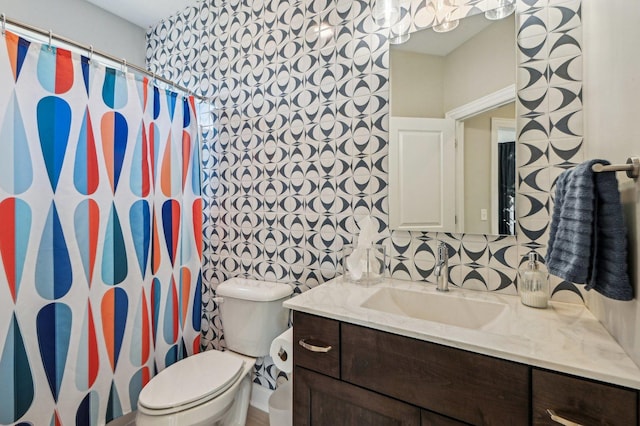 bathroom featuring curtained shower, toilet, and vanity