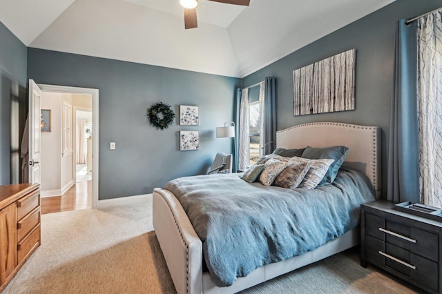 carpeted bedroom with baseboards, lofted ceiling, and a ceiling fan