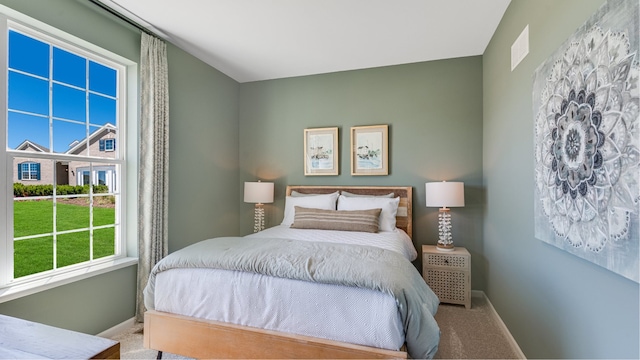 carpeted bedroom featuring baseboards