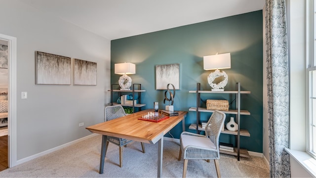 carpeted home office featuring baseboards