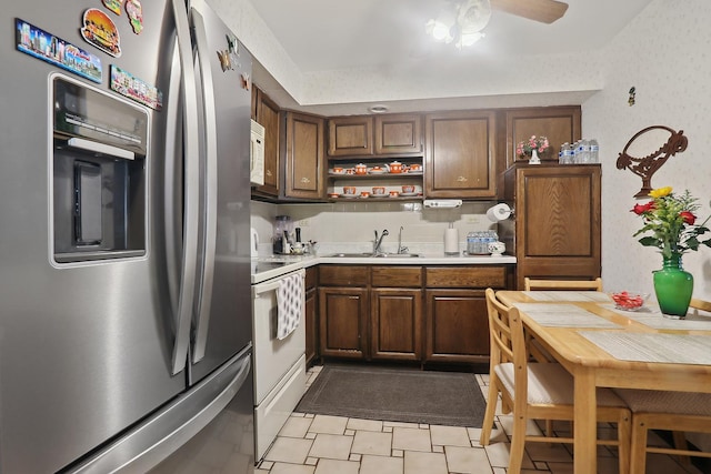 kitchen with white appliances, open shelves, ceiling fan, a sink, and light countertops