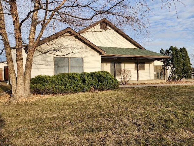 exterior space with a lawn and roof with shingles