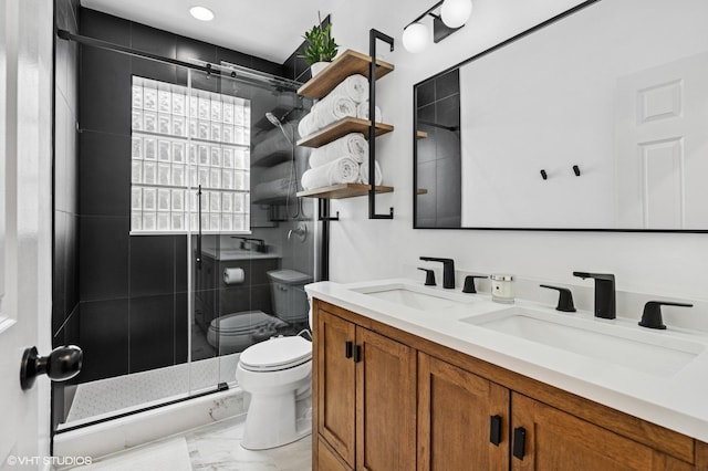 bathroom featuring a stall shower, marble finish floor, a sink, and toilet