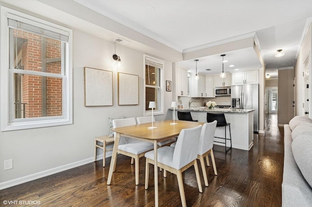 dining room featuring ornamental molding, dark wood-style flooring, and visible vents