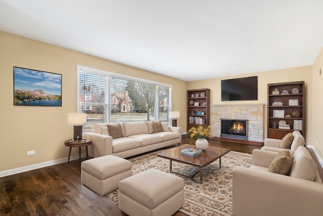 living room with built in features, a fireplace, baseboards, and dark wood-style flooring