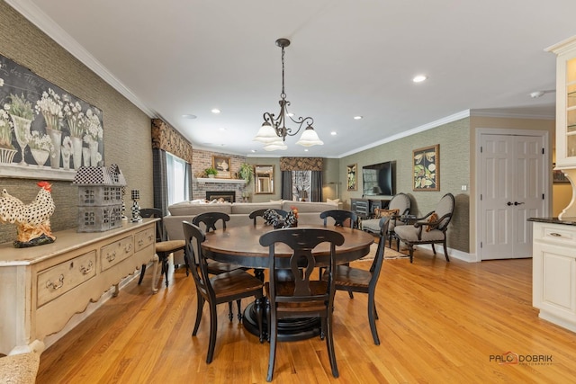 dining area with recessed lighting, light wood-style floors, a fireplace, and crown molding