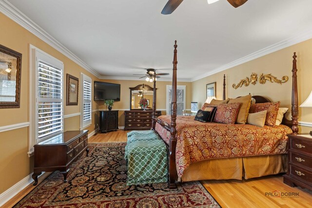 bedroom featuring baseboards, light wood-style floors, and ornamental molding