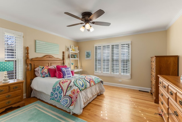 bedroom with light wood-style flooring, crown molding, baseboards, and ceiling fan