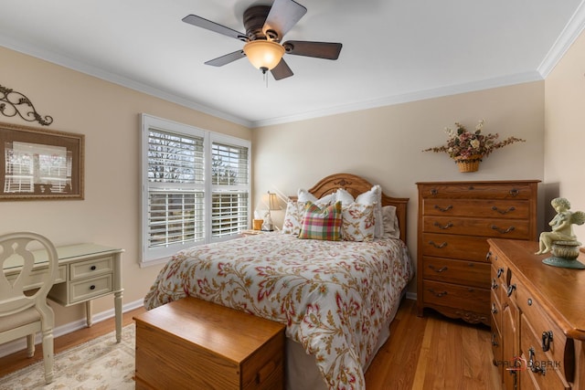 bedroom with baseboards, a ceiling fan, light wood-style floors, and ornamental molding