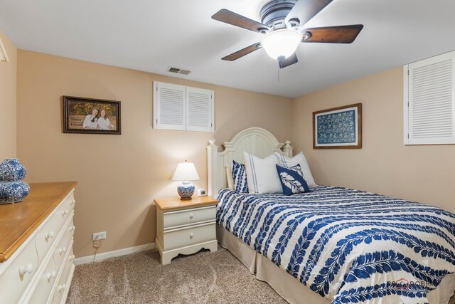 carpeted bedroom featuring visible vents, baseboards, and a ceiling fan