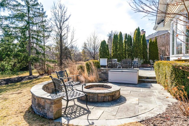 view of patio / terrace with an outdoor fire pit