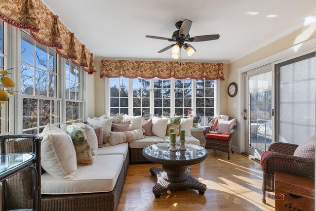 sunroom / solarium with a healthy amount of sunlight and ceiling fan