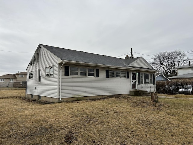 view of front of property featuring fence and a front lawn