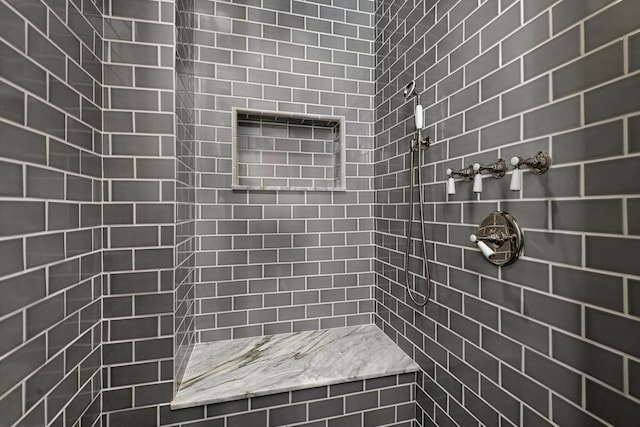 full bathroom with tiled shower