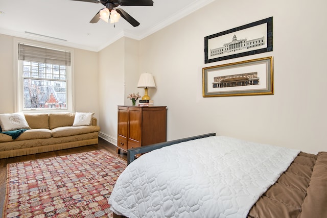 bedroom with ornamental molding, a ceiling fan, baseboards, and wood finished floors
