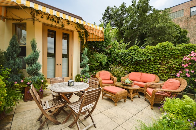 view of patio with outdoor dining space, an outdoor hangout area, and french doors