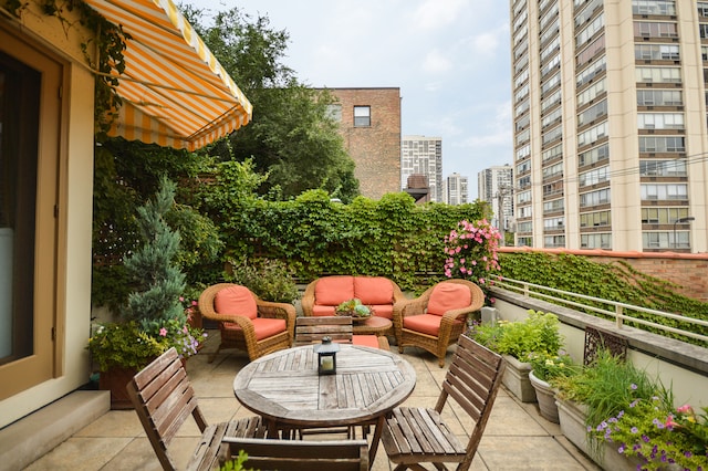 balcony with outdoor lounge area, a city view, and a patio