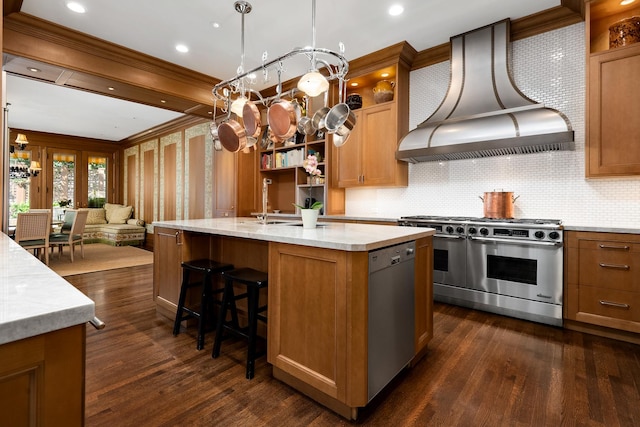 kitchen featuring stainless steel appliances, dark wood-type flooring, open floor plan, brown cabinetry, and custom range hood
