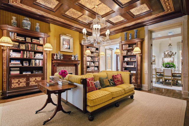 living area with a notable chandelier, wooden walls, coffered ceiling, wood finished floors, and crown molding
