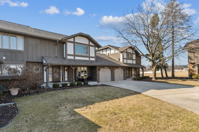 view of front of home featuring board and batten siding, concrete driveway, brick siding, and a front lawn