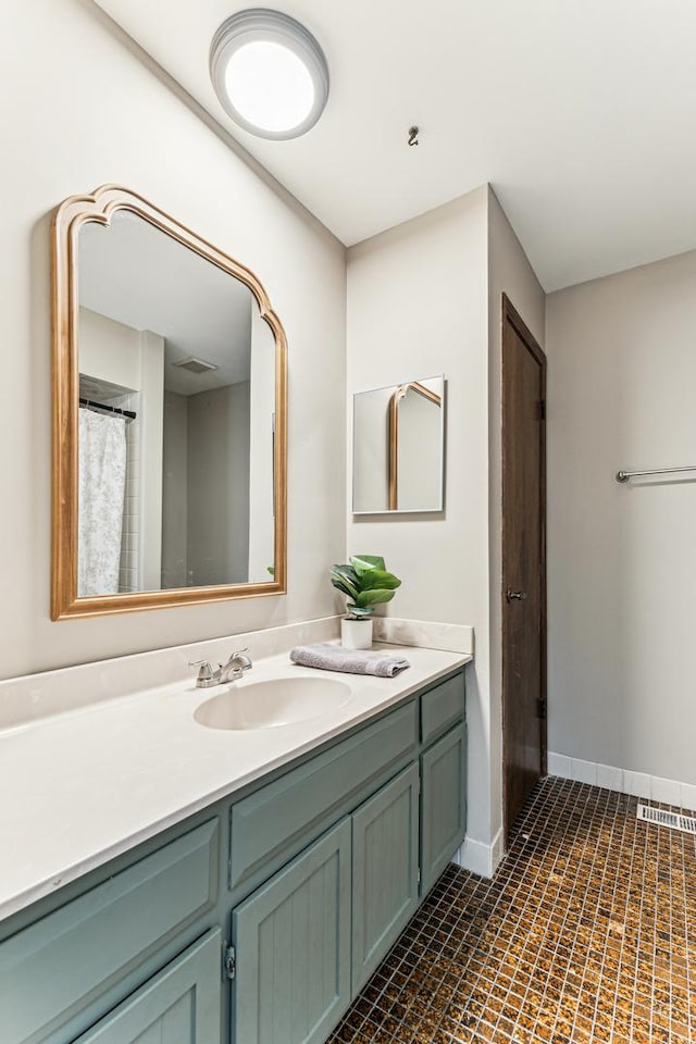 bathroom with visible vents, vanity, and baseboards