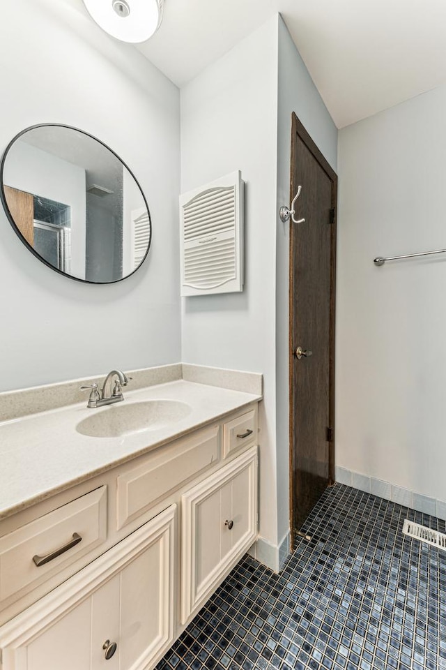 bathroom featuring vanity, tile patterned floors, and baseboards