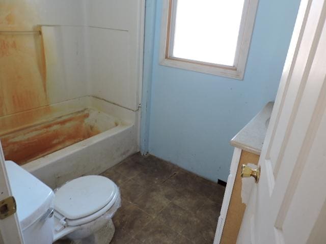 bathroom with bathing tub / shower combination, vanity, toilet, and tile patterned floors