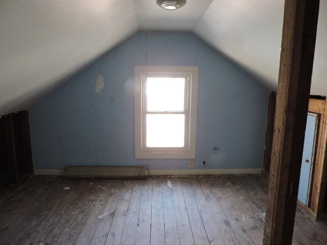 bonus room with lofted ceiling, wood-type flooring, and baseboards