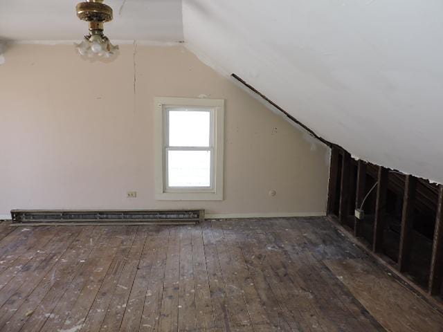 bonus room featuring lofted ceiling, a baseboard heating unit, and hardwood / wood-style floors