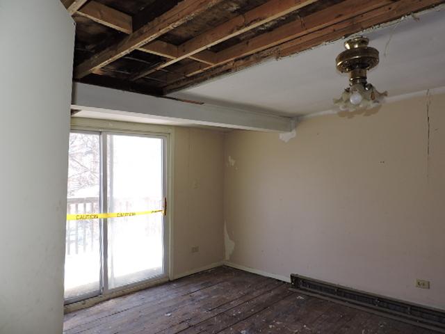 spare room featuring wood-type flooring