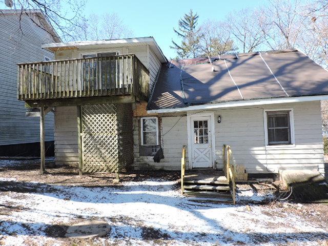 snow covered property featuring a wooden deck