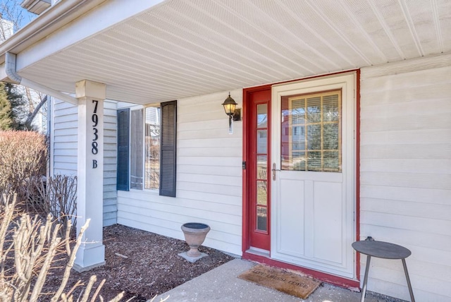 view of exterior entry featuring covered porch