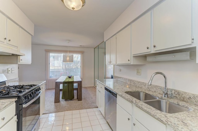 kitchen featuring light colored carpet, range with gas cooktop, stainless steel dishwasher, under cabinet range hood, and a sink