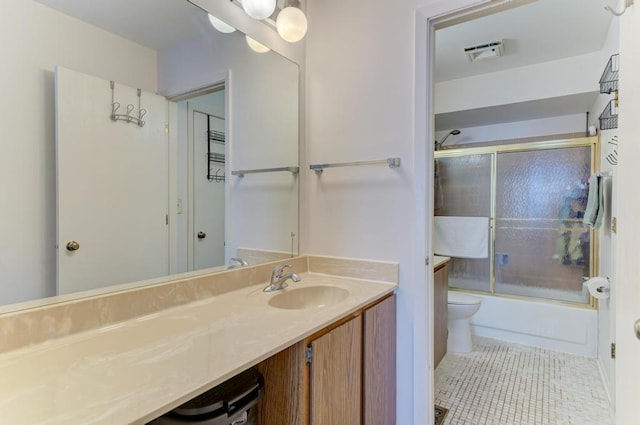 bathroom with tile patterned flooring, toilet, bath / shower combo with glass door, visible vents, and vanity