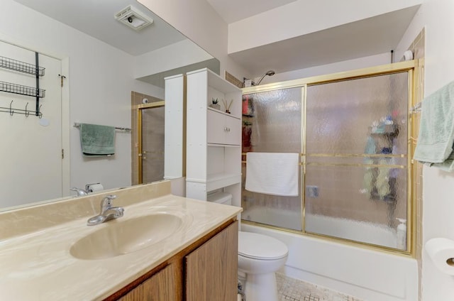 bathroom featuring visible vents, combined bath / shower with glass door, vanity, and toilet