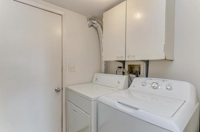 laundry room with cabinet space and washing machine and clothes dryer